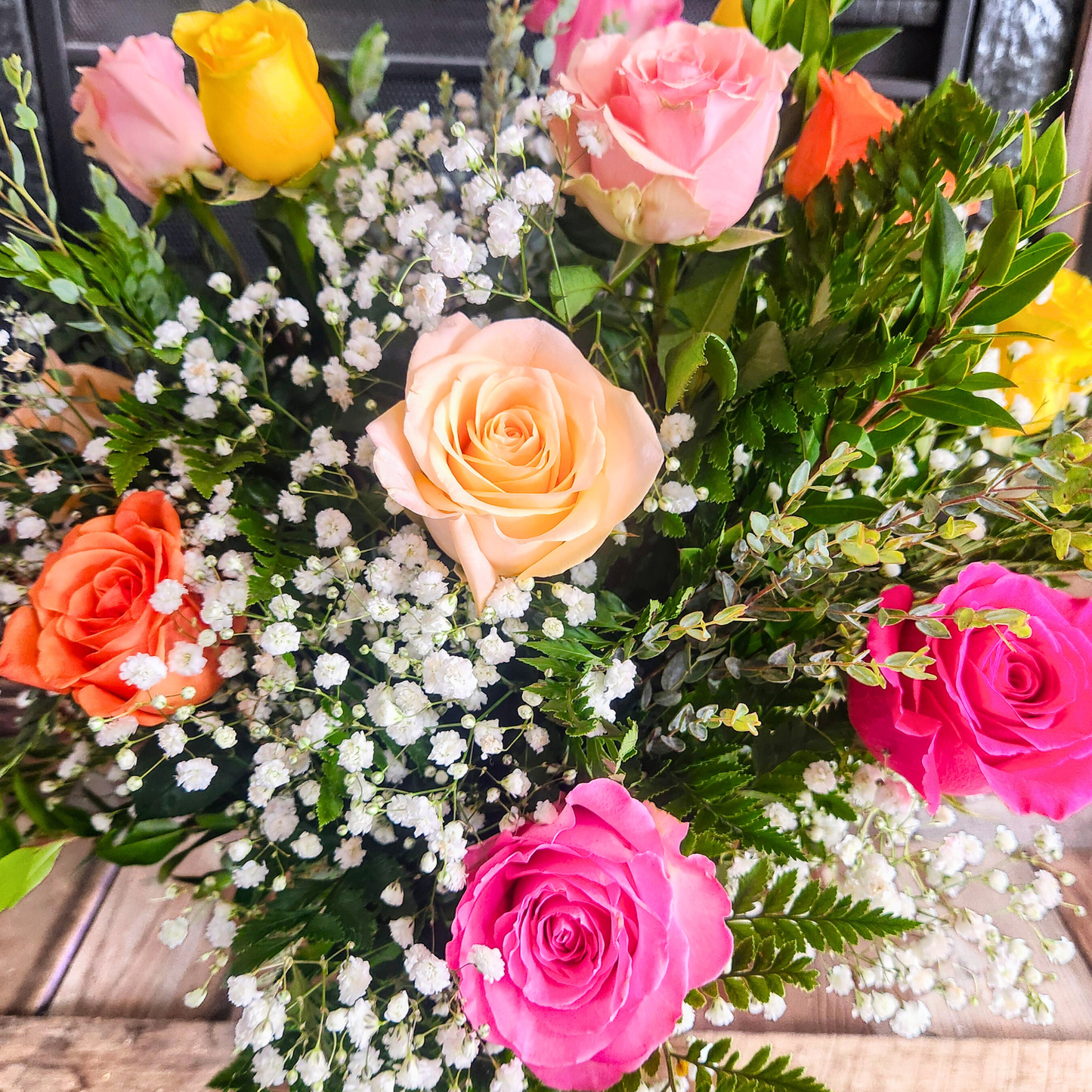 Full dozen mixed rose bouquet in a vase for the National Sweetheart Pageant during the National Sweet Corn Festival in Hoopeston, Illinois.