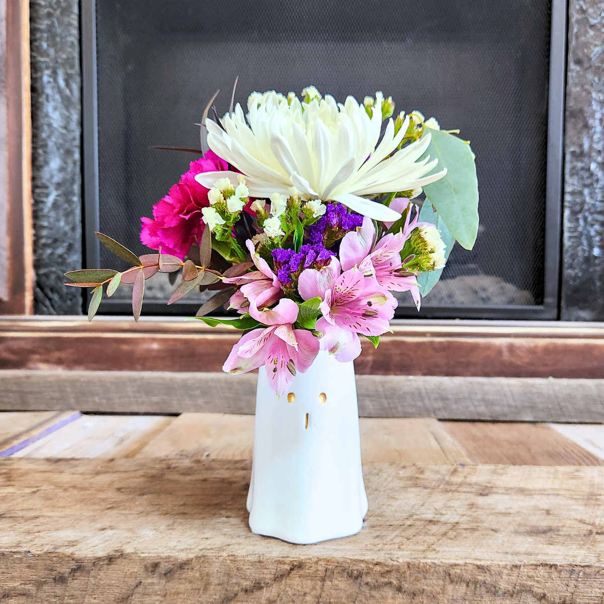 Boo-tiful Blooms fall arrangement with white, pink, purple, and green seasonal flowers in a white ghost vase from Treasured Roots Flower Shop in Hoopeston, IL.