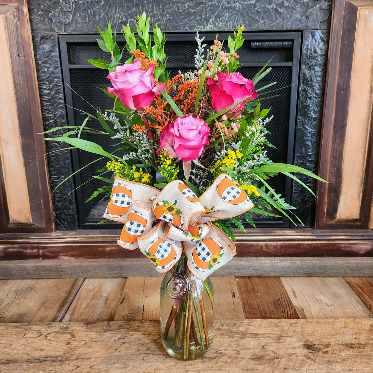 Tall Enchanted Harvest Bouquet with lavender-to-pink roses, seasonal fall accents, greenery, and a festive bow from Treasured Roots Flower Shop in Hoopeston, IL.