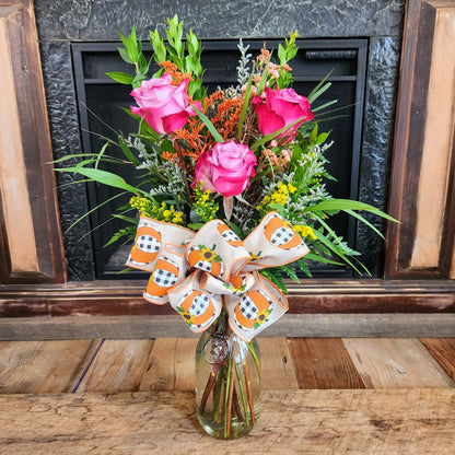 Tall Enchanted Harvest Bouquet with lavender-to-pink roses, seasonal fall accents, greenery, and a festive bow from Treasured Roots Flower Shop in Hoopeston, IL.