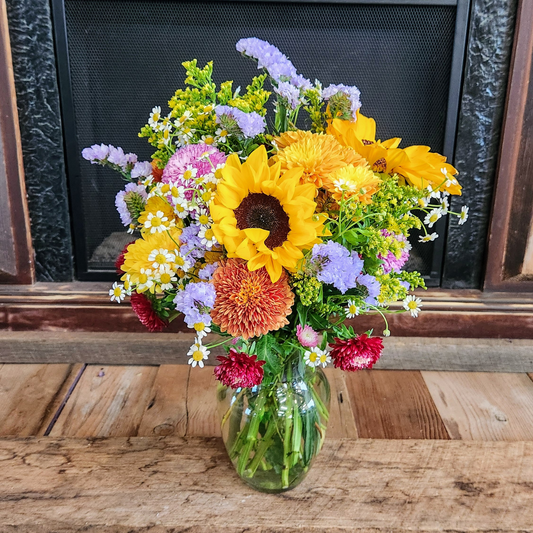 Golden Meadow fall bouquet with sunflowers, golden mums, orange cremones, red flowers, purple accents, and seasonal greenery from Treasured Roots Flower Shop in Hoopeston, IL.