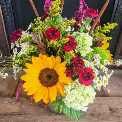 Close-up of Woodland Stroll showing sunflowers, green hydrangea, burgundy carnations, purple celosia, chamomile, solidago, and cattails from Treasured Roots Flower Shop in Hoopeston, IL.