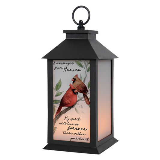 A black frosted lantern with a hanging bracket, featuring a colorful image of two cardinals on the front, with a quote and a flameless LED candle.